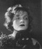Marlene with the mascot, her black felt doll, in her breakthrough film, The Blue Angel